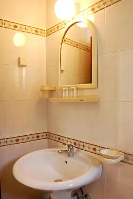 a bathroom with a sink and a mirror at Vila Mitrovic in Budva