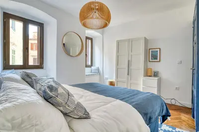a bedroom with a large bed and a mirror at Museum Palazzo Suite by MN Property in Kotor