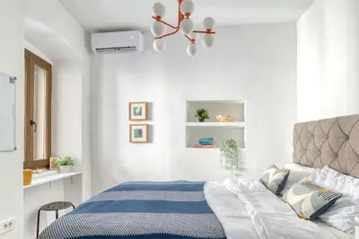 a bedroom with a bed and a ceiling fan at Museum Palazzo Suite by MN Property in Kotor