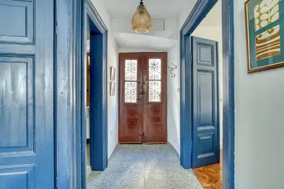 a hallway with blue doors and a window at Museum Palazzo Suite by MN Property in Kotor