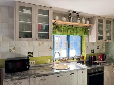 a kitchen with a sink and a microwave at Charming Cozy Home on the Beach in Kaluđerac