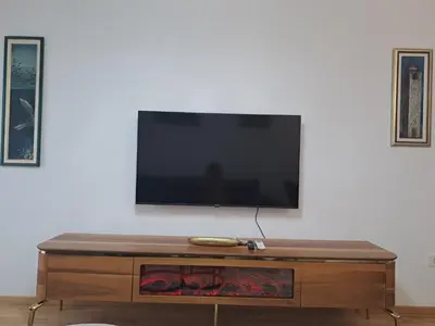a flat screen tv on top of a wooden table at Apartman Vlado Podgorica in Podgorica