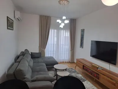 a living room with a couch and a flat screen tv at Apartman Vlado Podgorica in Podgorica