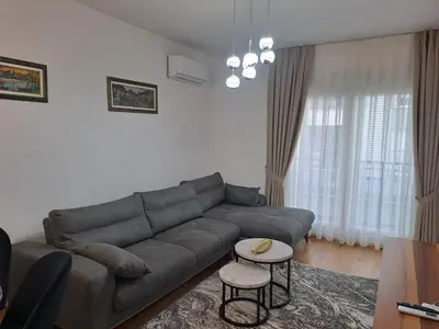 a living room with a couch and a table at Apartman Vlado Podgorica in Podgorica