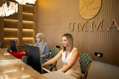 two women sitting at a table using a computer at Hotel Umma in Ulcinj