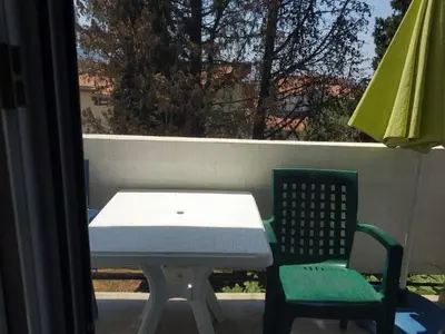 a table and two chairs on a balcony with a table and a table at Studio Dream III soba in Bar