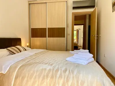 a bedroom with a bed with towels on it at Fiumera Kotor Apartment in Kotor