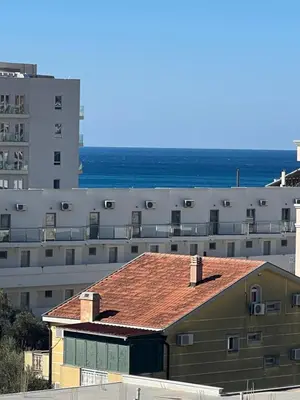 a building with a red roof in front of buildings at Engora 10 Voli in Petrovac na Moru