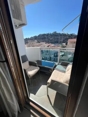 a balcony with a view of a couch and chairs at Engora 10 Voli in Petrovac na Moru