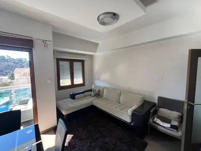 a living room with a couch and a window at Engora 10 Voli in Petrovac na Moru