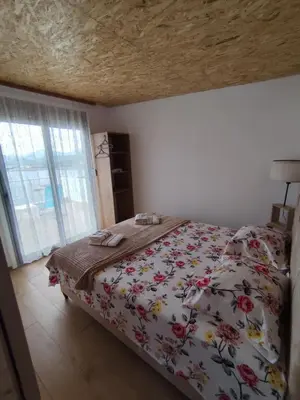 a bedroom with a bed with a floral bedspread at Apartment Sorelle in Utjeha