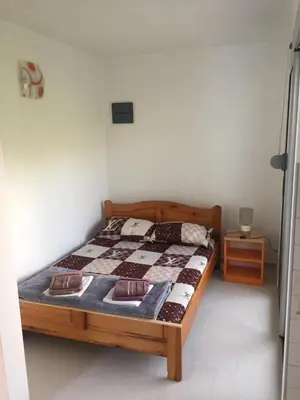 a bedroom with a bed with a quilt on it at Apartment Sorelle in Utjeha