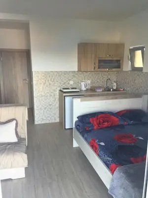 a kitchen with a bed with roses on it at Apartment Sorelle in Utjeha