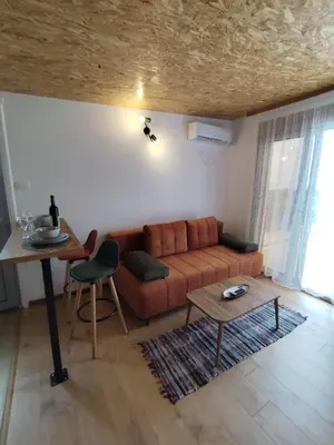 a living room with a couch and a table at Apartment Sorelle in Utjeha