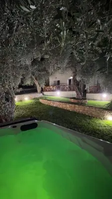 a swimming pool with green water in a building at Eman Villas in Ulcinj