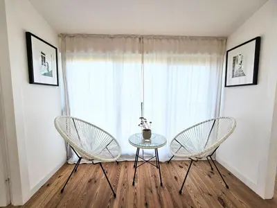 two chairs and a table in front of a window at Stone Villa at the Vrelo in Dobra Voda