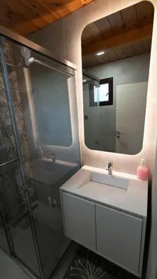 a bathroom with a sink and a shower with a mirror at Villa Ana in Ulcinj