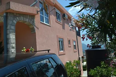 a car parked in front of a building with a window at Apartments Milosevic in Bar