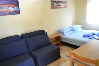 a room with a bed and a couch and a table at Apartments Milosevic in Bar
