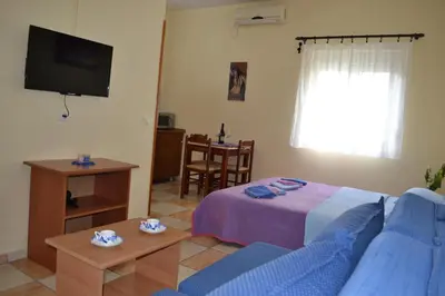 a living room with a bed and a tv at Apartments Milosevic in Bar