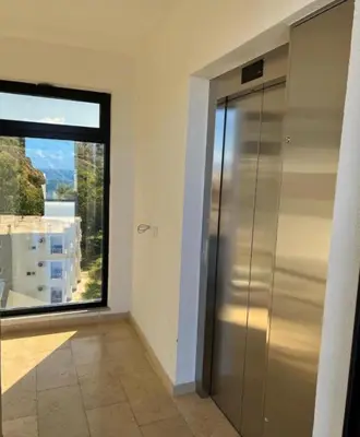 a elevator in a room with a large window at Apartmani Beba in Bar