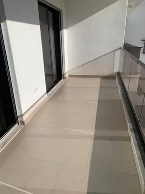 an empty room with a tile floor and windows at Apartmani Beba in Bar