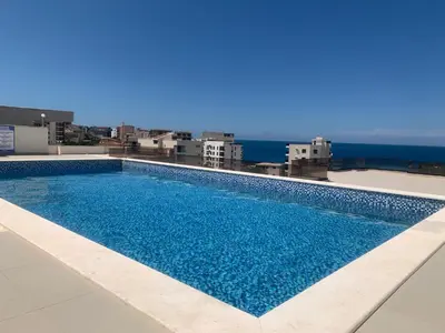 a swimming pool on the roof of a building at Apartmani Beba in Bar