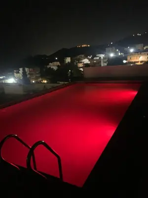 a red lighted object on a roof at night at Apartmani Beba in Bar