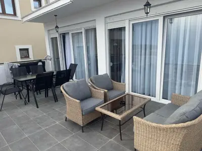 a balcony with chairs and a table and a dining room at Vila AS Krimovica in Krimovice