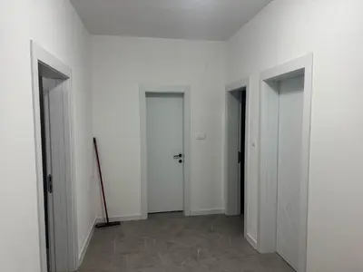 a hallway with three doors in a white room at Vila AS Krimovica in Krimovice