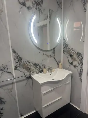 a white bathroom with a sink and a mirror at Vila AS Krimovica in Krimovice