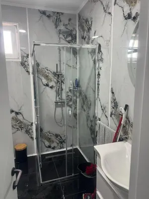 a bathroom with a shower and a sink at Vila AS Krimovica in Krimovice