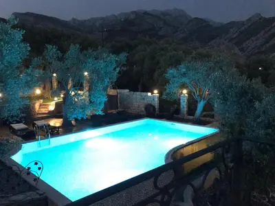 a swimming pool in a backyard at night at Apartments Villa St. Bar in Bar