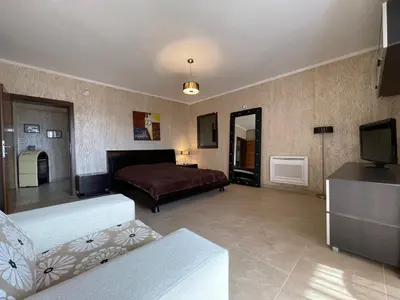 a living room with a bed and a television at Apartments Villa St. Bar in Bar