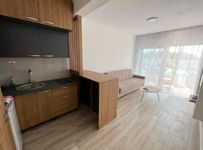 a kitchen with a sink and a couch in a room at Apartment Complex with Pool in Bar, Montenegro in Bar
