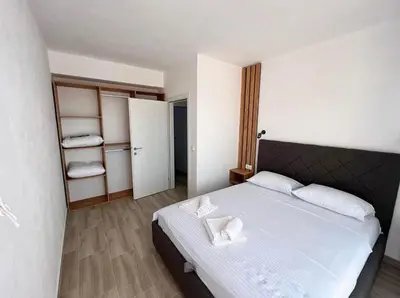 a bedroom with a bed with two towels on it at Apartment Complex with Pool in Bar, Montenegro in Bar