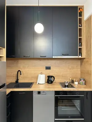 a kitchen with black and white cabinets and a sink at Tre Sorelle in Podgorica