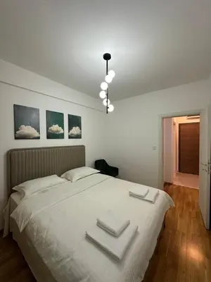 a bedroom with a bed with three towels on it at Tre Sorelle in Podgorica
