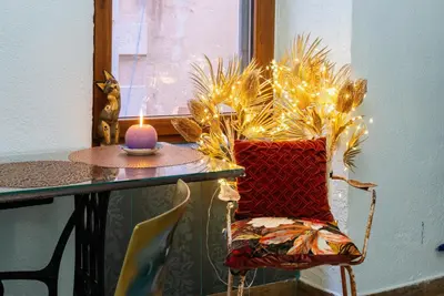 a candle sitting on top of a table with a chair at Artintime Apartments in Kotor