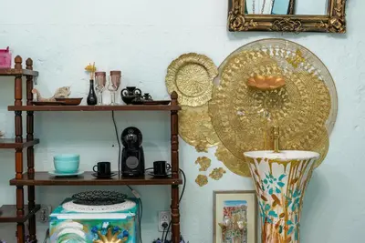 a wall with shelves and a mirror and a vase at Artintime Apartments in Kotor
