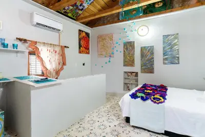 a white room with a bed and a counter at Artintime Apartments in Kotor