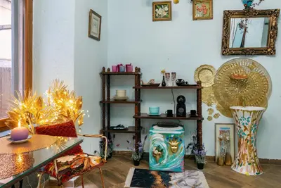 a living room with a table and a shelf at Artintime Apartments in Kotor