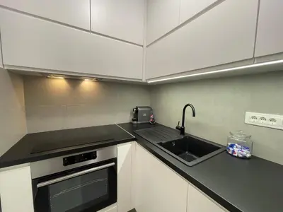 a kitchen with a sink and a stove at Apartman Ognjen in Bar
