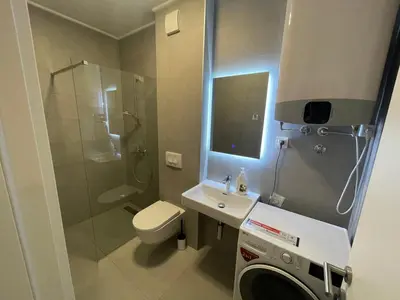 a bathroom with a shower and a toilet and a sink at Apartman Ognjen in Bar