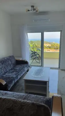 a living room with a couch and a table at Meli Apartman in Krimovice