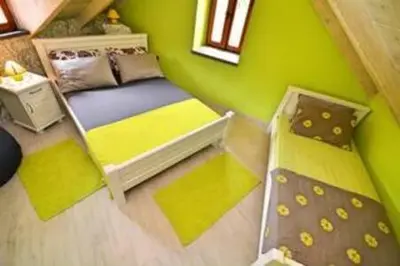 a small room with a bed and a green wall at Old Town Gem - Rooftop Terrace with Bay View in Kotor