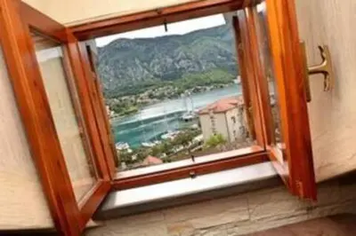 a window in a room with a view of the water at Old Town Gem - Rooftop Terrace with Bay View in Kotor