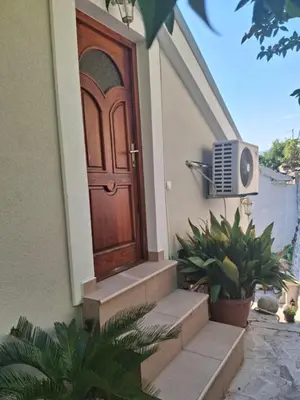 a wooden door of a house with stairs and plants at Old Town Gem - Rooftop Terrace with Bay View in Kotor