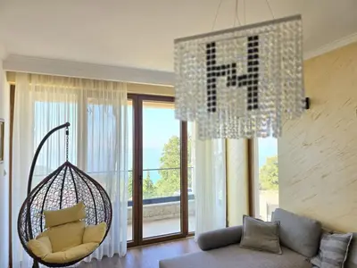 a living room with a couch and a chandelier at Villa Trend, Budva, Kuljače in Budva