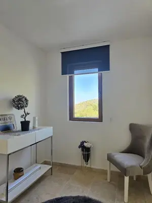 a living room with a chair and a window at Villa Trend, Budva, Kuljače in Budva